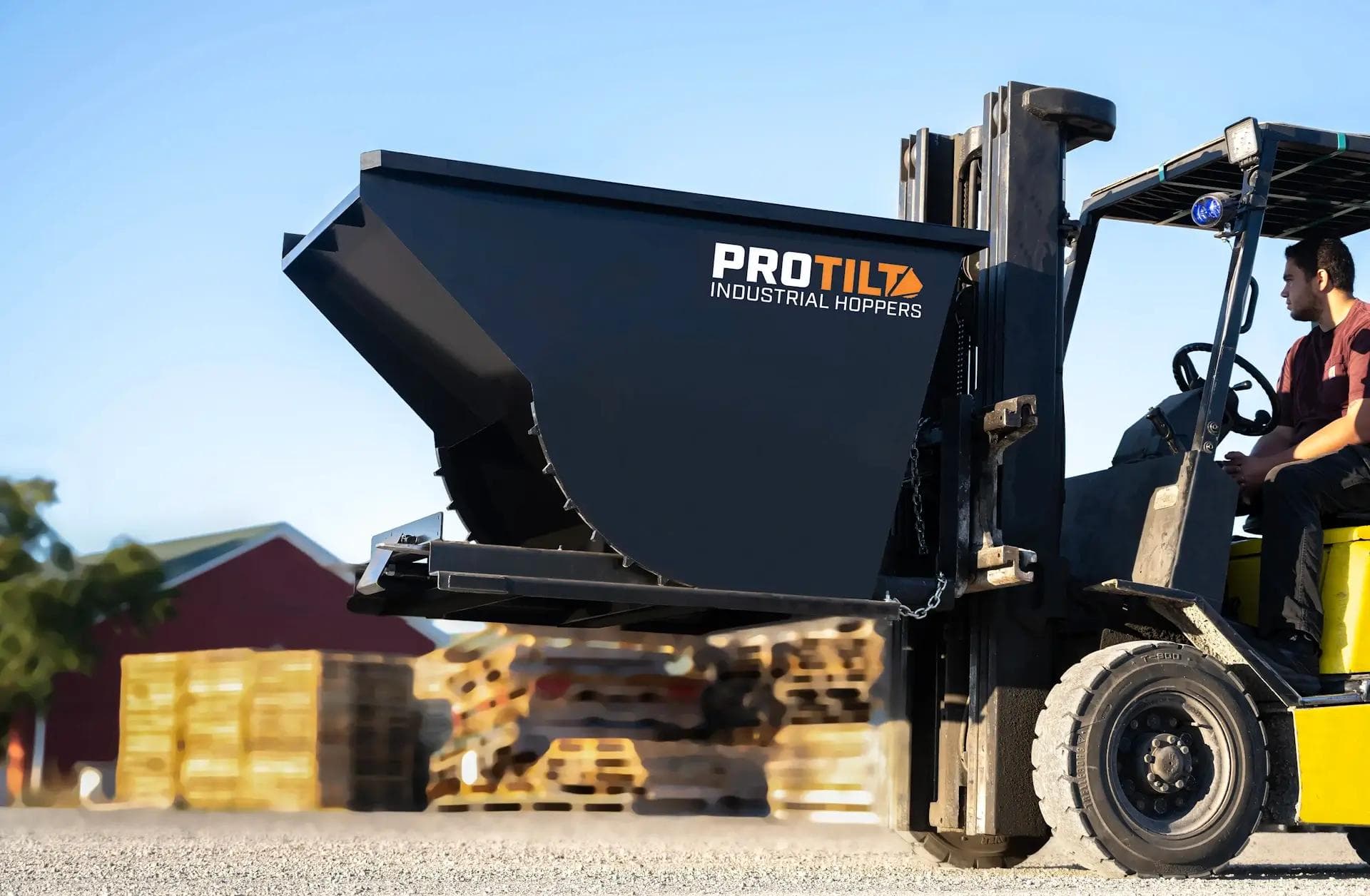 PROTILT self dumping hopper on a forklift ready for industrial material handling.